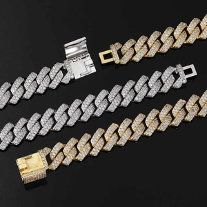 Detail of 14mm iced out Cuban link chains in gold, silver, and bicolor with micro pavé stones