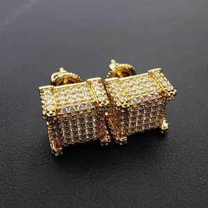 Macro detail of square hip hop earrings with gold finish and iced out zircon stones