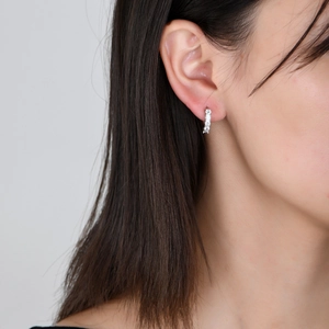 Iced out silver huggie earrings with five cubic zirconia stones for hiphop style