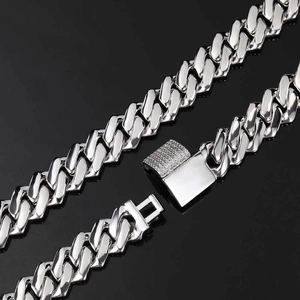 Macro shot of 14mm silver Cuban link chain with zircon-studded box clasp detail