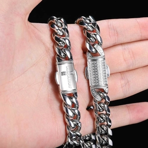 Detail of silver iced out Cuban chain with a cross pattern box clasp and white zircons