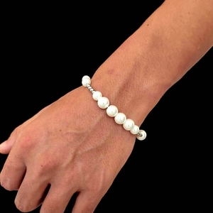Elegant Korean style pearl bracelet with silver spacers on a model's wrist
