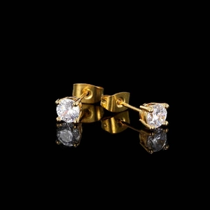 Detail of round cubic zirconia stud earrings with gold plating and four-prong setting