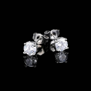 Macro shot of silver hip hop round zircon stud earrings with classic four-prong settings