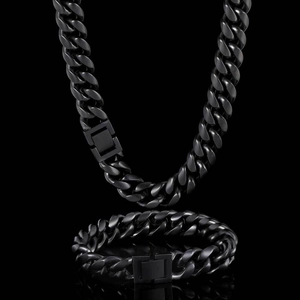 Close-up of matte black stainless steel Cuban link necklace and bracelet set