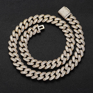 Macro detail of 15mm 18K gold Cuban chain with baguette and round cubic zirconia pavé