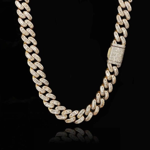 Macro shot of 15mm 18K gold Cuban link necklace with iced out baguette zircon stones