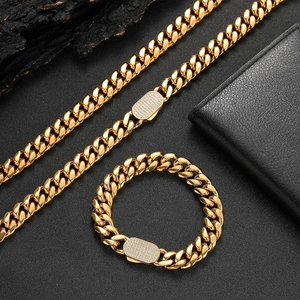 Detail of gold Cuban link chain set with sparkling iced out rhinestone pave clasp