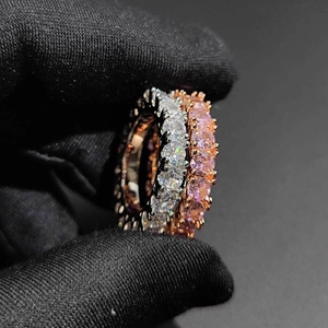 Macro shot of three stacked eternity bands with cubic zirconia in rose gold and silver
