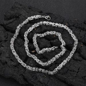Silver 4mm stainless steel Byzantine chain necklace with lobster clasp on dark stone