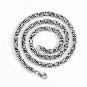 Macro detail of 4mm stainless steel Byzantine chain necklace with lobster clasp closure