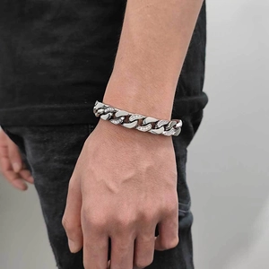 Men's 12mm stainless steel Cuban link bracelet with half-pave CZ stones on the wrist