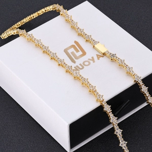 Detail of gold hip hop tennis chain with star-shaped links and zircon stone inlay