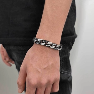 Detailed close-up of 12mm dual-tone Cuban link bracelet with zircon inlay on male wrist