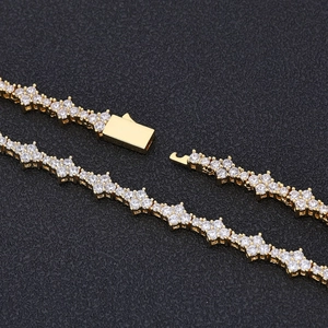 Macro shot of gold-plated tennis chain with cubic zirconia and secure box clasp closure