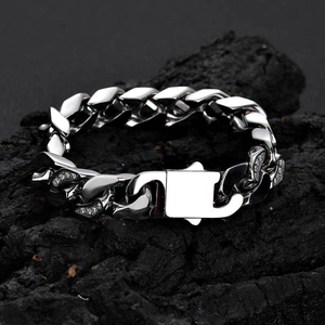 Macro view of 12mm silver Cuban link bracelet with CNC zircon inlay on textured rock