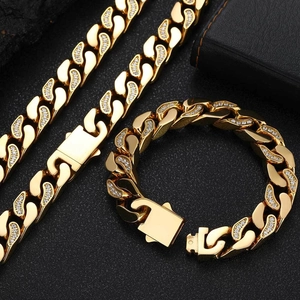 Detailed macro view of 12mm gold Cuban link bracelet with CNC set cubic zirconia stones