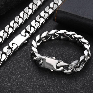 Detail of 12mm stainless steel Cuban link chain with CNC set zircons and teardrop hollows