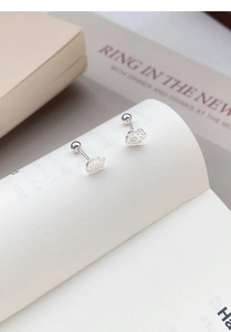 Macro detail of asymmetric S999 silver cat paw and fish stud earrings with screw back design