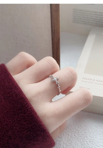 Detailed view of an S925 sterling silver cross ring with zircon stone on finger