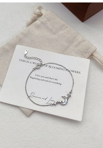 Detail of S999 silver moon and star bracelet with mother of pearl and cubic zirconia