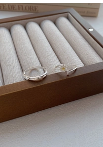 S999 silver rings with jasmine flower and woven texture in a wooden jewelry box