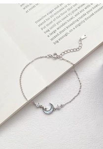 Detail of S925 silver bracelet with moon charm, white mother of pearl and zircon stones