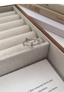 Detail of S925 sterling silver adjustable ring with iris cross and white agate gemstone