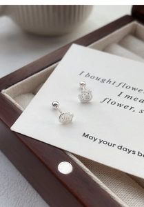 Macro view of S925 silver cat paw and fish stud earrings with secure screw backs
