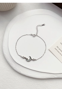 Detail of S999 silver star and moon bracelet featuring white mother of pearl and S925 stamp