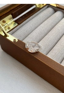 Detailed close-up of a S999 sterling silver adjustable ring with cute horse and coin symbols