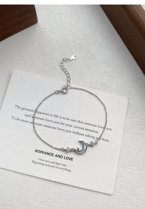 Detail of S925 sterling silver star and moon bracelet with white mother of pearl inlay