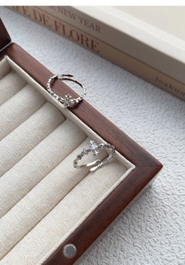 Detail of S925 sterling silver cross star ring with zircon in a jewelry box
