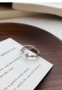 Detailed macro view of S925 silver cross ring with cubic zirconia on floral band