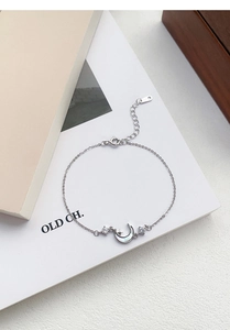 Detail of S999 silver star and moon bracelet with mother-of-pearl inlay and thin chain