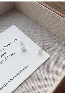 Detailed macro view of S999 sterling silver fish and cat paw stud earrings with screw back