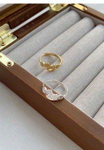 Detail of adjustable S999 silver horse coin rings in gold and silver finish with symbols