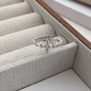S925 silver star cross ring with zircon stone shown at a 45-degree angle in a jewelry box
