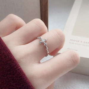 S925 sterling silver cross ring with star zircon on thorn band worn by a woman