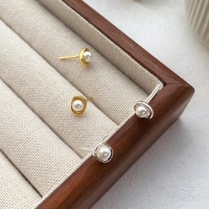 Elegante S925 Sterling Silber Perlenohrringe in Gold und Silber auf einem Holzdisplay