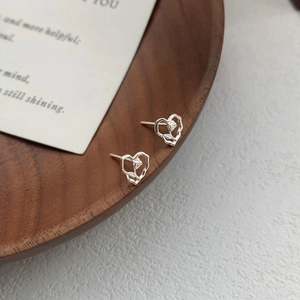 Minimalist S999 sterling silver heart-shaped rose stud earrings with hollow design