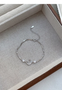 Macro shot of S925 sterling silver moon bracelet with zircon charms on jewelry tray