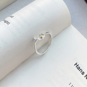 S999 sterling silver open jasmine ring with gold stamen on vintage book background