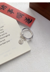 Detailed macro shot of an S925 sterling silver adjustable ring with a lucky Fu charm