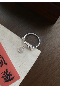 Close-up of S925 sterling silver adjustable ring with traditional Fu character pendant