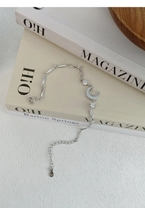 Detailed macro view of S999 sterling silver moon bracelet with S999 hallmark and zircon