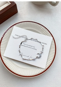 Detail of S925 sterling silver moon and star bracelet with white shell inlay and zircon