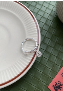 Macro detail of S925 sterling silver ring featuring a round Fu pendant and adjustable band