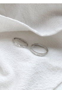 Detailed macro view of S999 silver open rings featuring engraved butterfly and sun patterns