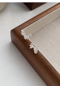 Detailed close-up of S999 sterling silver koi fish stud earring with screw back design